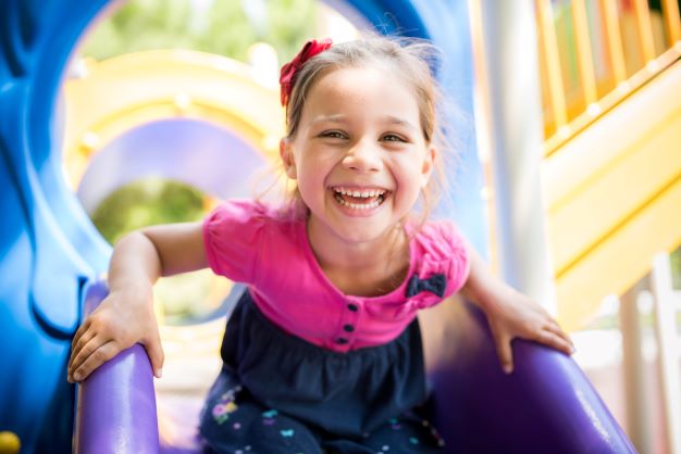 girl smiling on slide