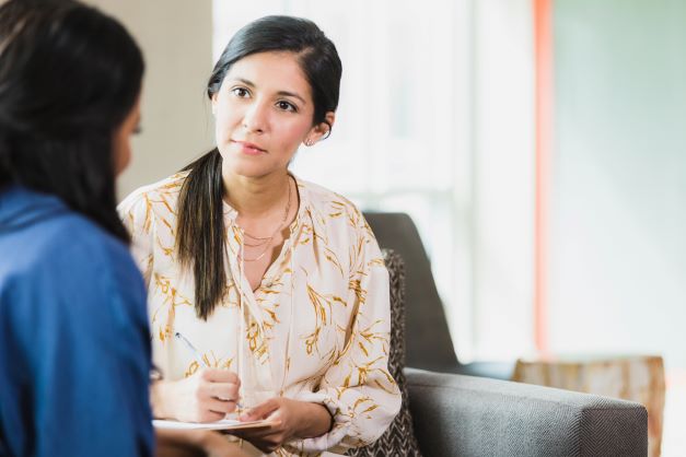 young lady speaking with therapist