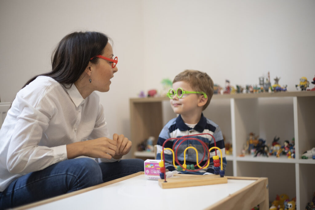 Three years old boy having a play therapy session with the psychotherapist.