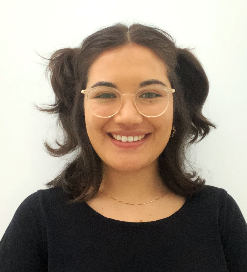 Image of Graduate Speech Pathologit, Kyra. Smiling at the camera, she is wearing round framed glasses with clear lenses, a black crew neck top and dark brown hair which is to her shoulders. 