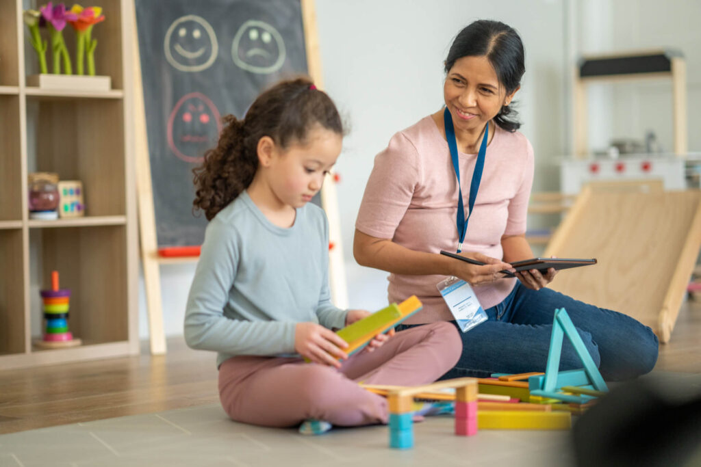Child participating in a psychology assessment with a caring professional