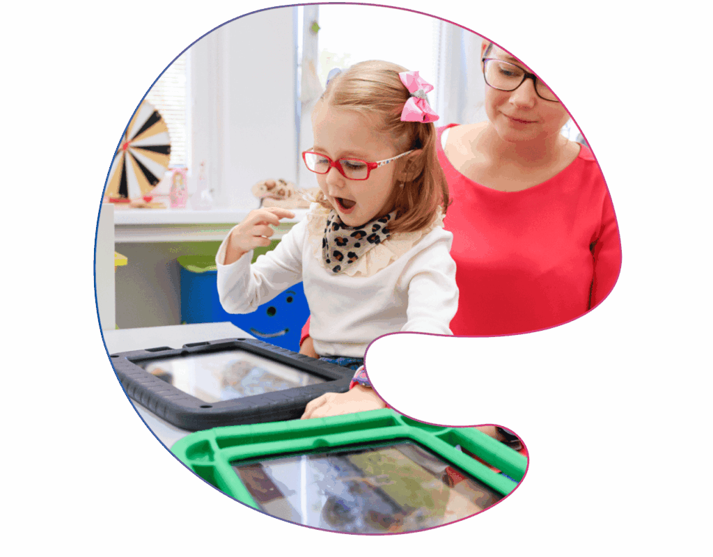 Speech therapist engaging in a play-based session with a young girl to support language development