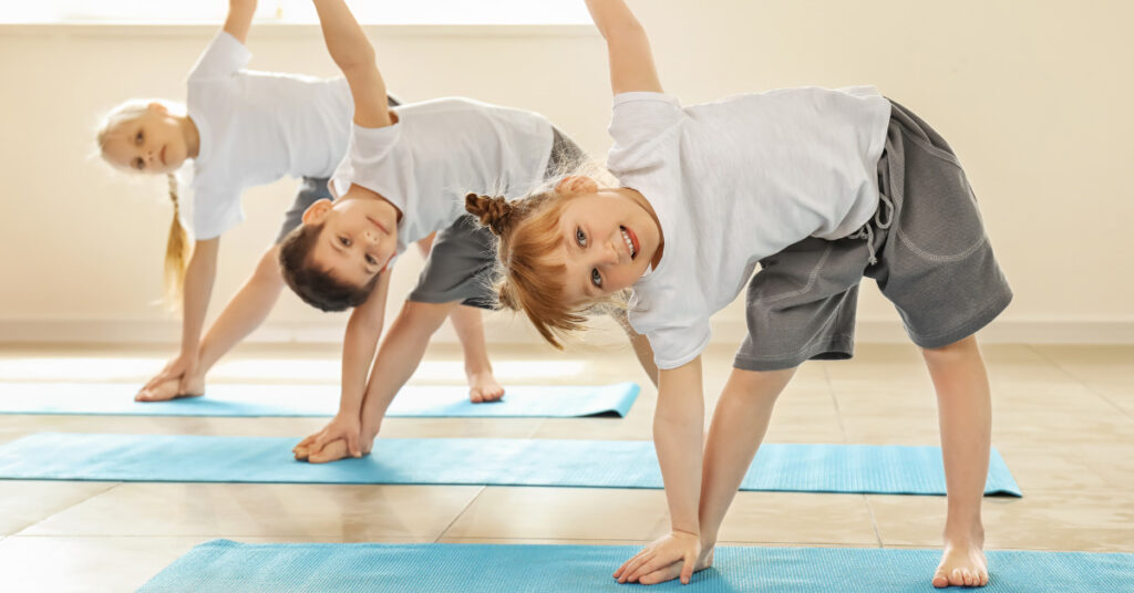 Therapist guiding paediatric client through posture-strengthening exercises