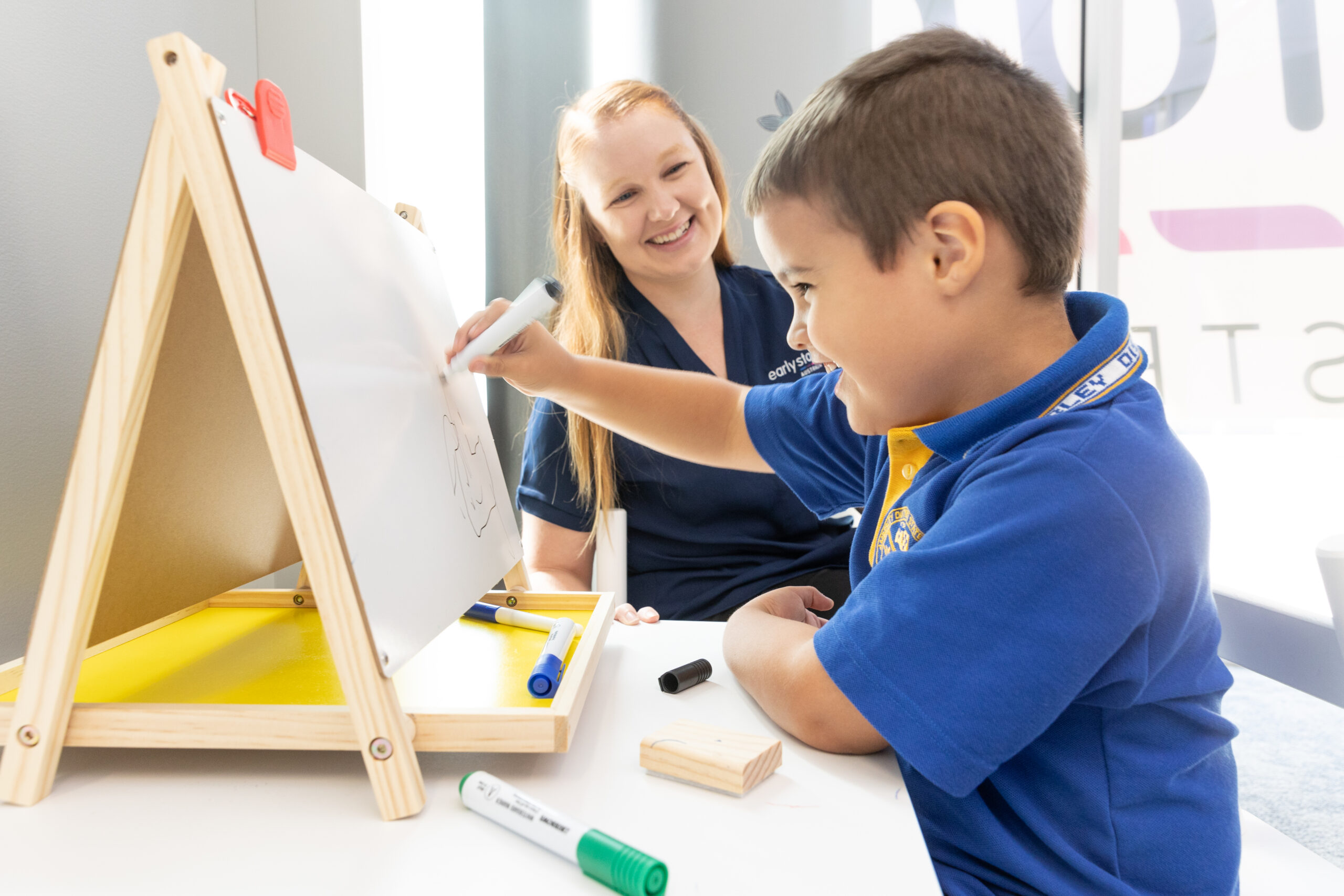 boy and therapist with easel fine motor scaled